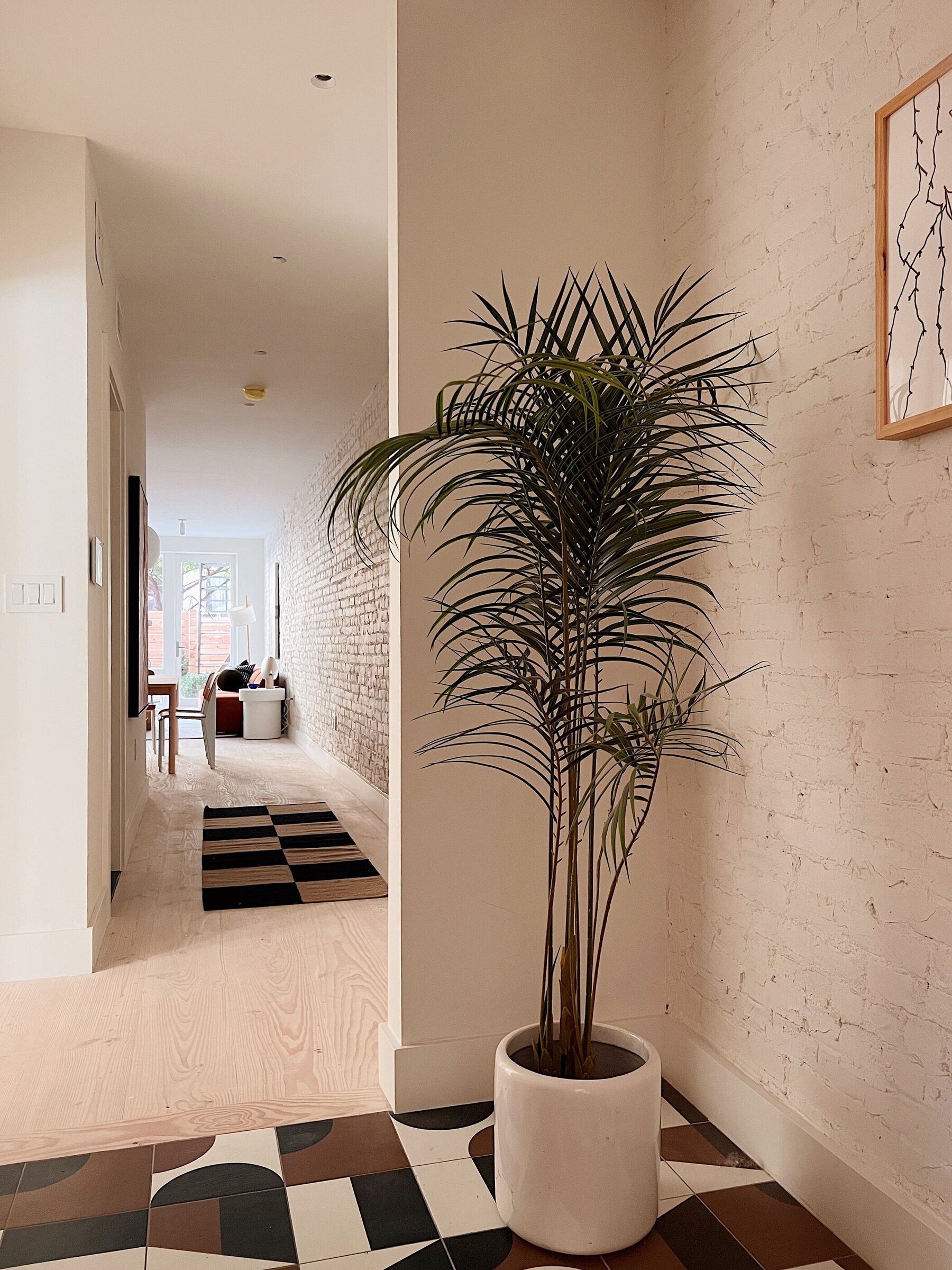 Entry hall with white-painted brick at 239 President Street