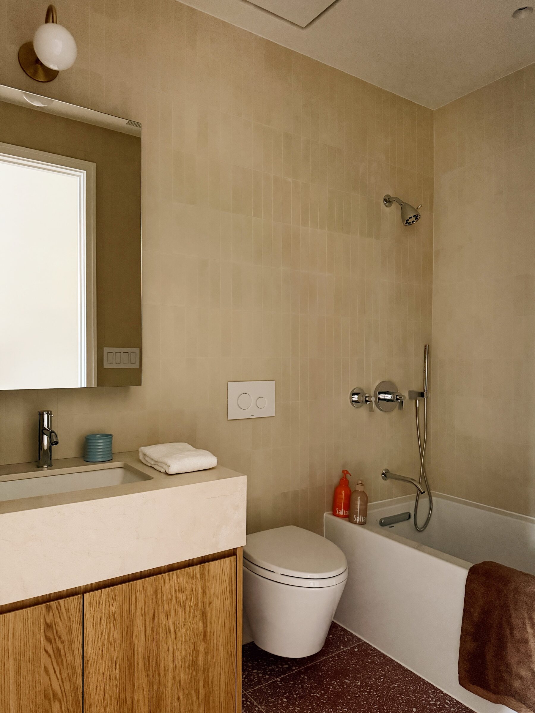 Warm stone and oak bathroom at 34 Garfield Place