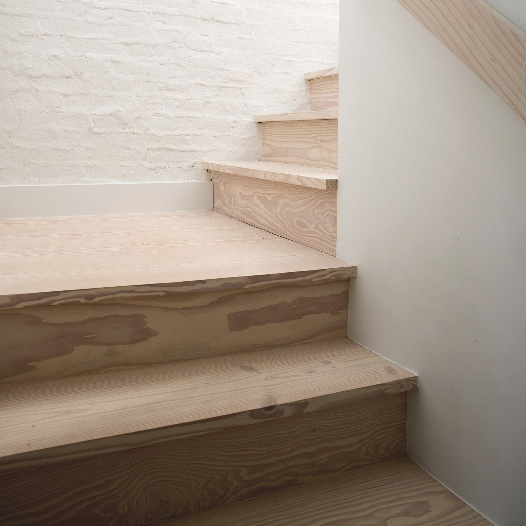 Light wood stair and painted brick detail at 42 Garfield Place
