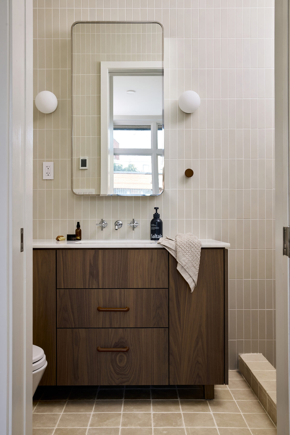 Walnut vanity and tiled bathroom at 44 Garfield Place