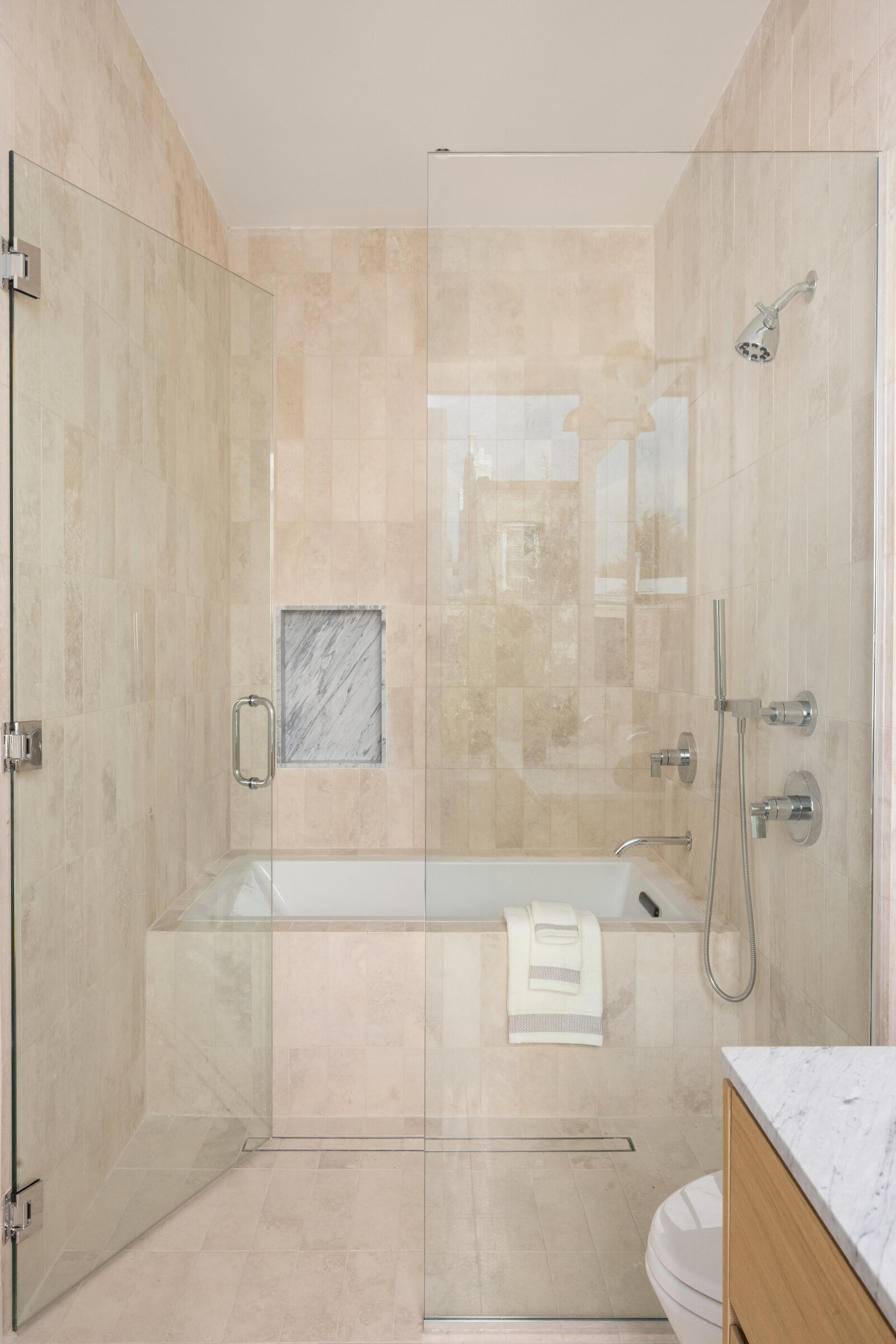 Stone-lined bathroom and glass shower at 591 10th Street